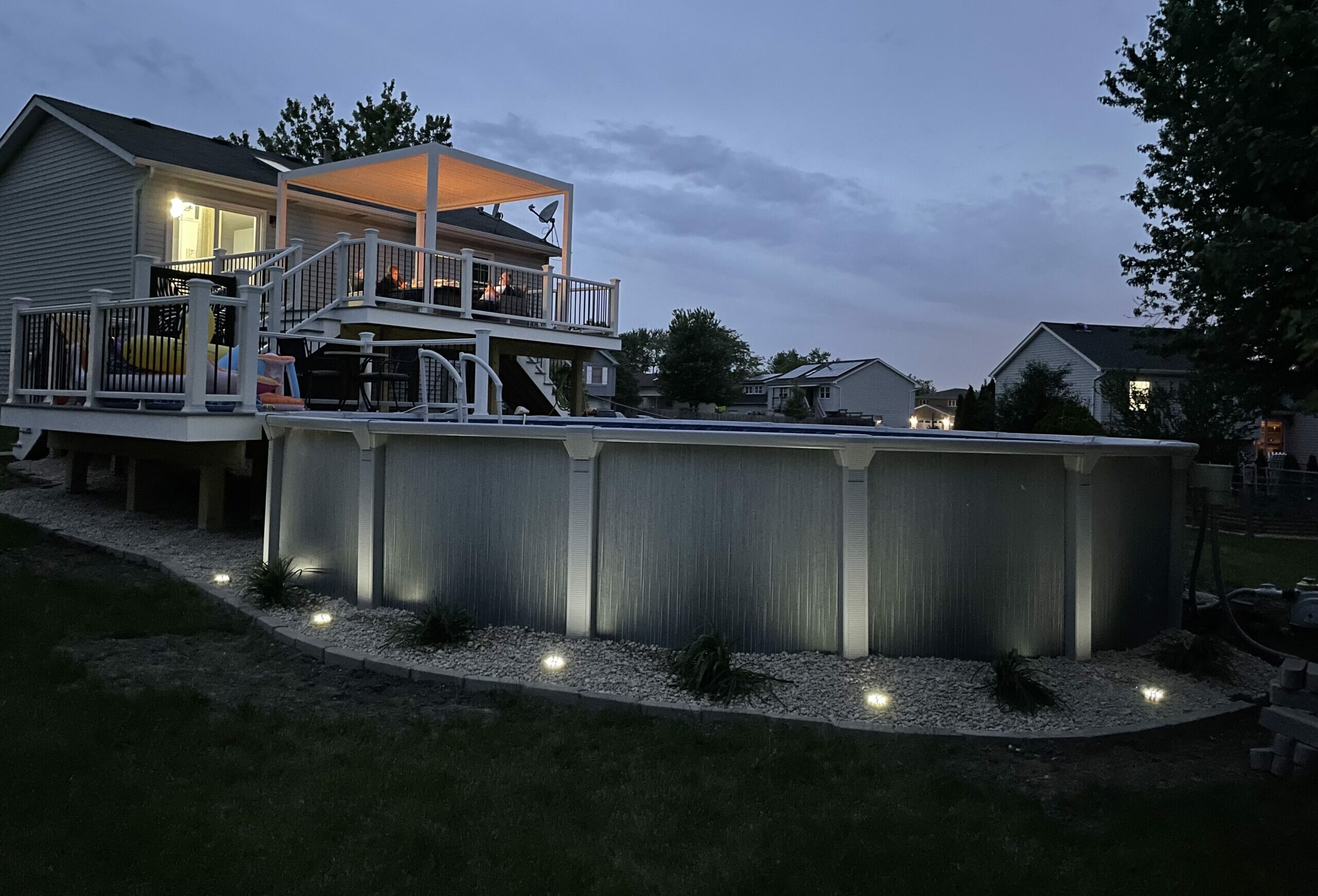 multi level pool deck with outdoor lighting and renovated landscape